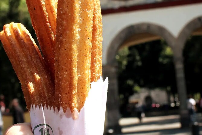 Frida Kahlo VIP [Museum Tickets Included] Walk, Markets & Churros - Jardín Centenario: church architecture meets modern sculpture
